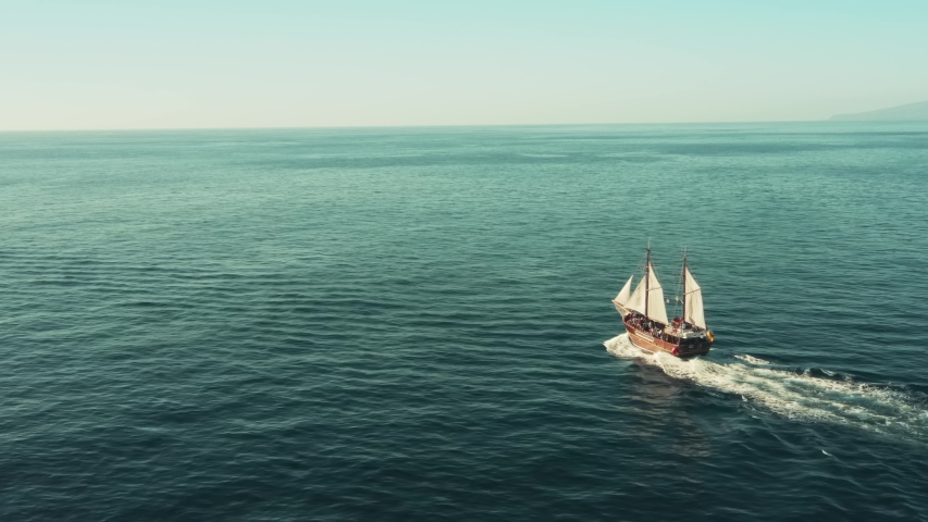 A pirate sailboat in the open ocean rushes towards adventure Royalty-Free Stock Footage #1047860953