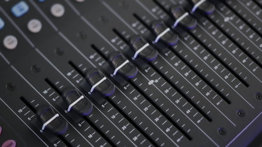 Automated faders move on audio mixing board console  | Shutterstock HD Video #1047860956