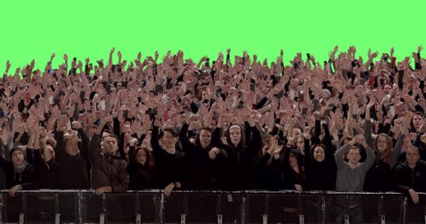 GREEN SCREEN CHROMA KEY Model released, Front view of huge crowd dancing and cheering at a concert or a show behind control barrier. Shot on RED Helium 8K Prores 4444