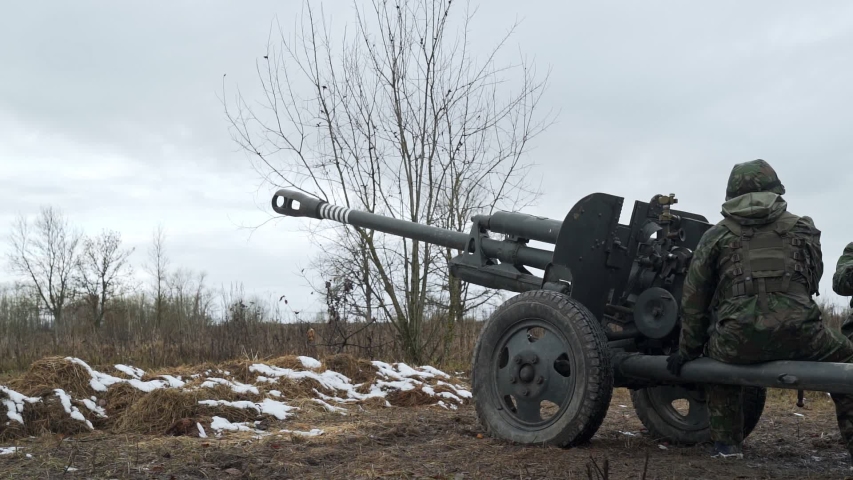 Cannon shot. Military exercise. Soldiers in the field. Slow motion