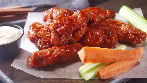 Delicious breaded buffalo chicken wings with  ranch dip, celery and carrot.
