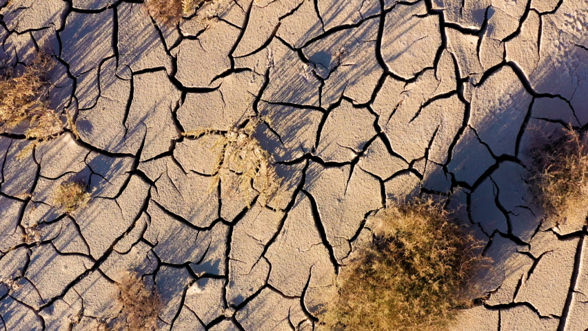 Looking down at the cracked surface of a dry river