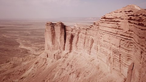 Drone flight of rugged mountain scenery and surreal landscape of the Tuwaiq Escarpment and Edge of the World in Saudi Arabia
