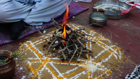 Homa or havan fire ceremony performed at home. Incense and ghee are thrown into fire .Homa havan ritual according to vedic tradition.performing homa, hindu prayer