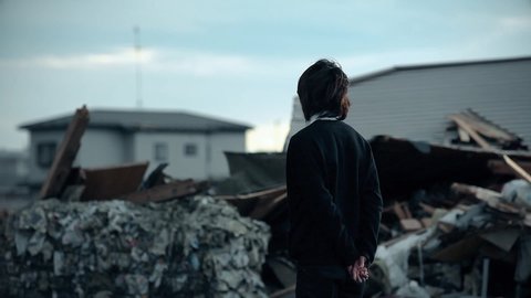 Fukushima, Japan - 03/11/2011 : a man is looking at the ruins of the city, after the tsunami