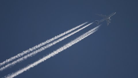 NOVOSIBIRSK, RUSSIA - SEPTEMBER 18, 2019: Air China Boeing 747 flying at high altitude with contrail