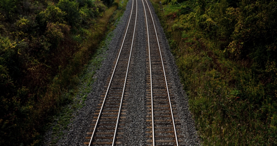 4K time lapse long exposure of fast passenger train during rush hour. 2 way railroad transportation into and out of city. fast motion blur 