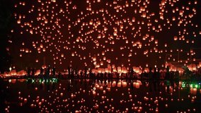 thousands of floating fire paper lanterns in the night sky with reflection in the pool at yee peng festival. Loy Krathong celebration, Chiangmai, Thailand - Powered by Shutterstock - Get 15% off with code: PIKWIZARD15