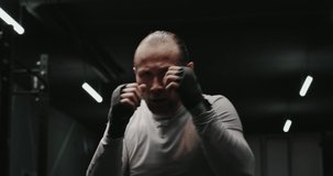 MMA fighter with bandaged hands throwing punches