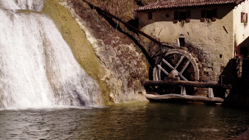 Mill with the wheel stopped near a waterfall