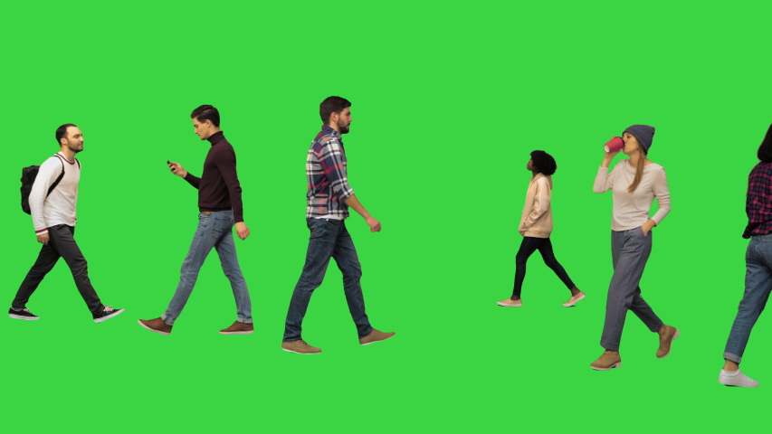Different casual people walking by on a Green Screen, Chroma Key. | Shutterstock HD Video #1048017040