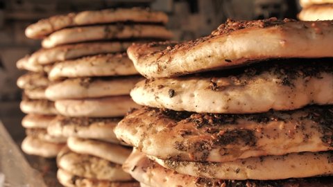 Freashly baked arab flatbreads at Mahane Yehuda Market in Jerusalem. Mediterranean Pita Bread with zaatar. Manakish or Za'atar bread. A popular Levantine food (Lebanese cuisine. Cuisine of Israel