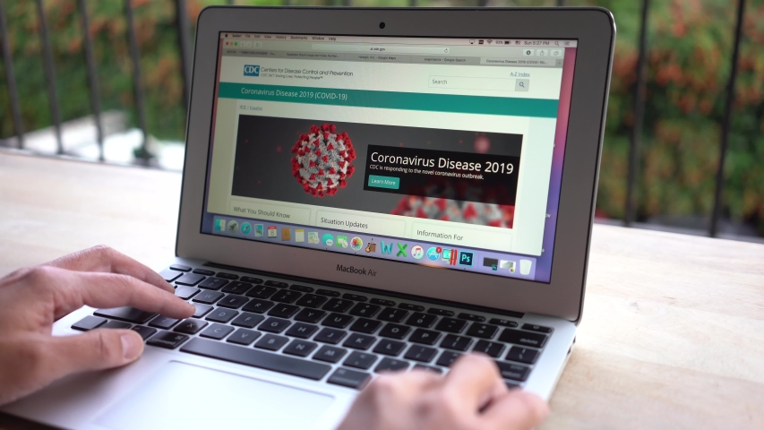 Portland, OR, USA - Mar 8, 2020: A man browsing the CDC website to learn key facts about the Coronavirus Disease 2019. | Shutterstock HD Video #1048033993