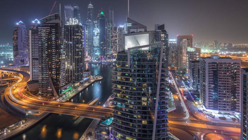 Aerial view of Dubai Marina residential and office skyscrapers with waterfront during all night timelapse with blinking lights turning off. Floating boats and yachts | Shutterstock HD Video #1048048591