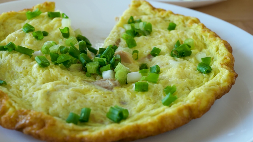 Sliced pices omelette with green onion. Sweet food with chicken meat