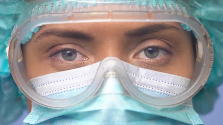 Doctor woman face, close-up. Doctor eyes safety glasses. be h3althy. Female doctor face, extreme closeup portrait. Doctor looking at camera. Medical Research Laboratory Officer. Coronavirus COVID-19. Royalty-Free Stock Footage #1048049917
