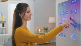 Beautiful Young Female Interacts with Augmented Reality Display. She's Changing Climate Control Setting to Higher Temperature. Smart Home Concept with Transparent Screen Made with VFX Special Effects. - Powered by Shutterstock - Get 15% off with code: PIKWIZARD15