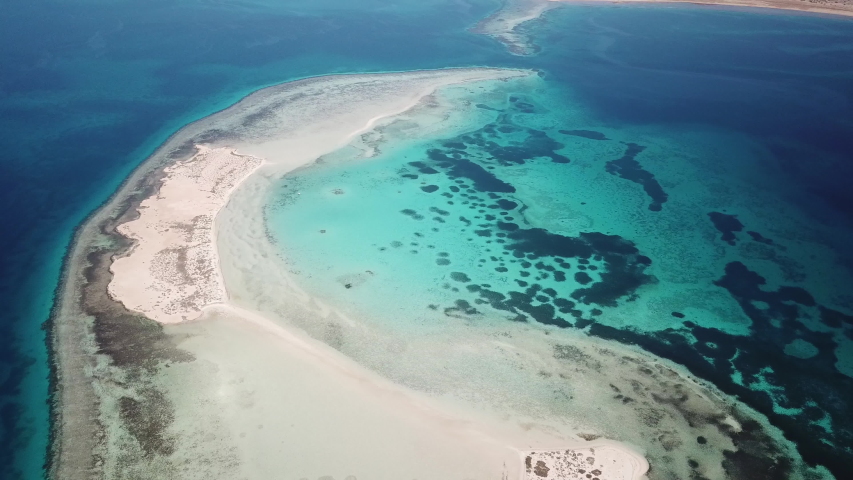 High angle drone flight of small strip of sand connecting two unspoiled islands in the Red Sea, natural landscapes and scenery in Saudi Arabia
 Royalty-Free Stock Footage #1048061887