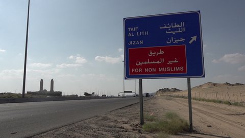 MECCA, SAUDI ARABIA – DECEMBER 2019: Traffic sign warning non Muslims to take the next turn, diverting from Mecca, the holiest city in Islam, in Saudi Arabia
