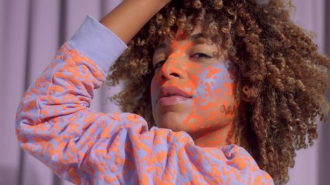 Closeup portrait of mixed race woman with neon makeup . new beauty concept, authentic identity