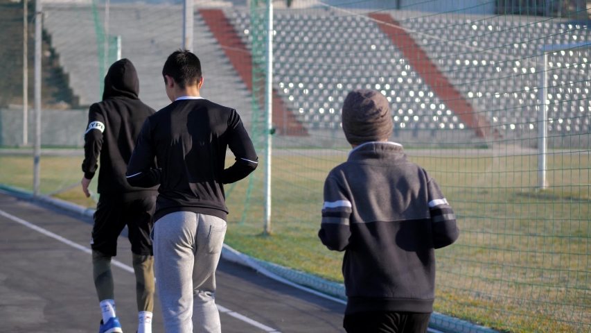 Warm - up of young athletes before training. morning fitness. jogging.