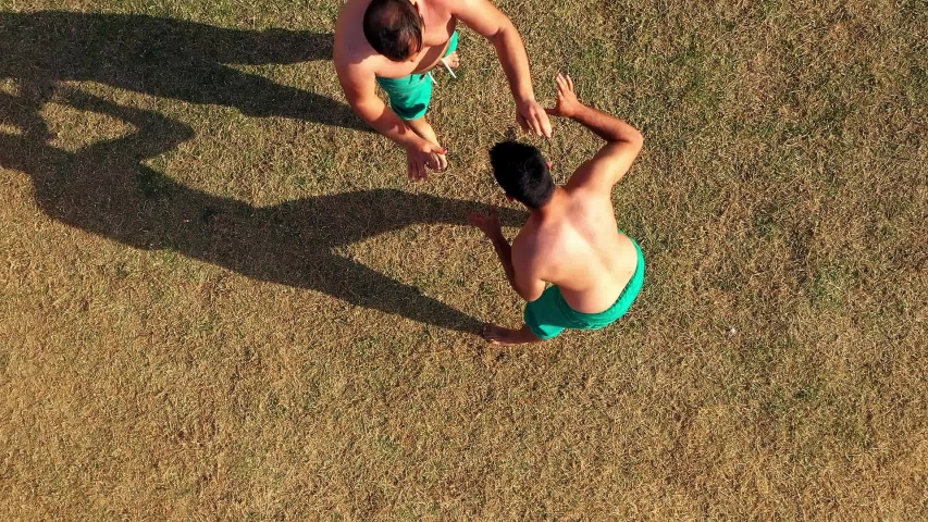 Turkish traditional oil wrestling in open air field from aerial view.
