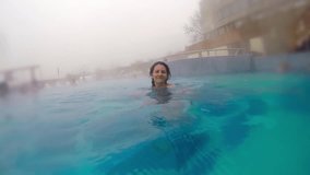 Attractive female at spa thermal pool, slow motion stock video