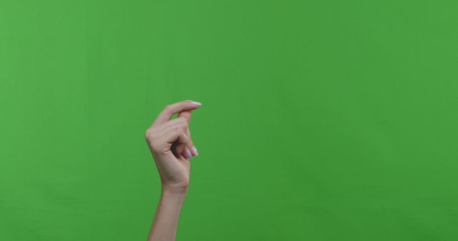 Woman snapping her fingers over green chroma key background. 4k Royalty-Free Stock Footage #1048077151