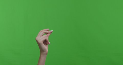 Woman snapping her fingers over green chroma key background. 4k