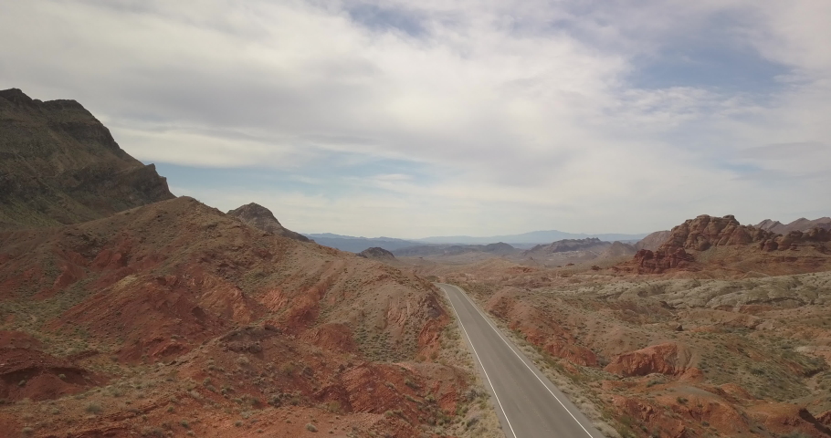 Aerial next to a 2 lane road in desert mountain pass