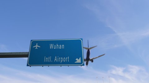 wuhan airport sign airplane passing overhead china