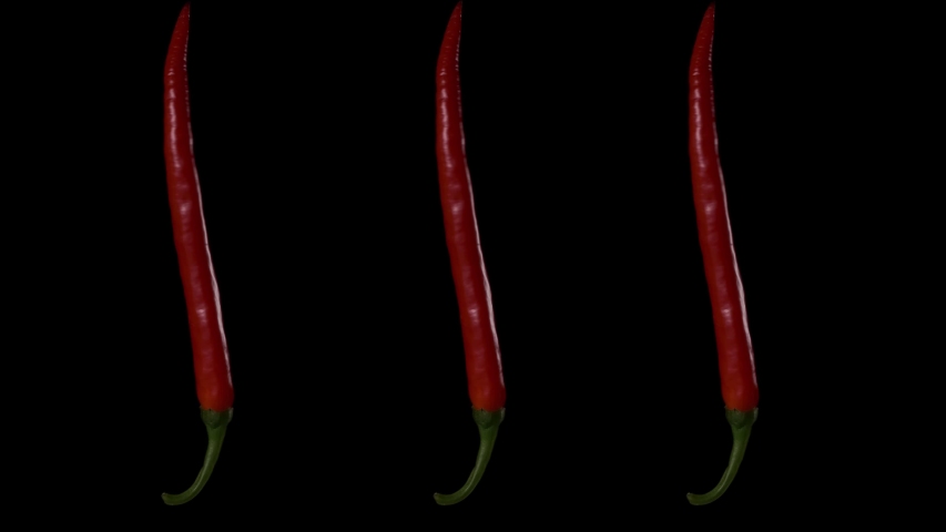 Three pods of red hot pepper rotate on a black background. | Shutterstock HD Video #1048103761