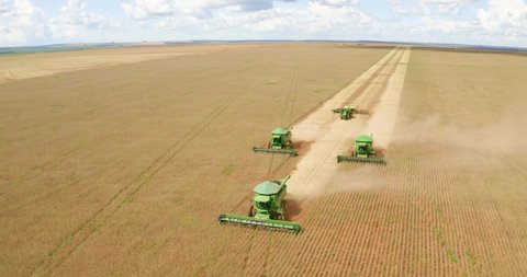 Monte Alegre de Minas, Minas Gerais, Brazil, February 27, 2020: Agriculture - Aerial image - beautiful positioning of agricultural machinery in arrow during soybean harvest with planting in Brazil - A
