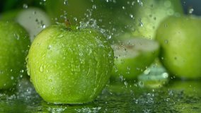 Super Slow Motion Shot of Water Splashing on Fresh Green Apple at 1000fps. - Powered by Shutterstock - Get 15% off with code: PIKWIZARD15