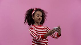 happy african american kid taking selfie isolated on pink