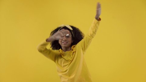 happy african american kid dancing isolated on yellow