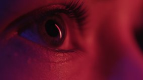 Eyes of Woman in Colourful Neon of Street Sign. Urban Female Looks Around at Studio Indoors. Flickering Multi-Colour of Ultra-Violet. Close Shot of Beautiful Girl with Frightened Face in Red Lighting - Powered by Shutterstock - Get 15% off with code: PIKWIZARD15