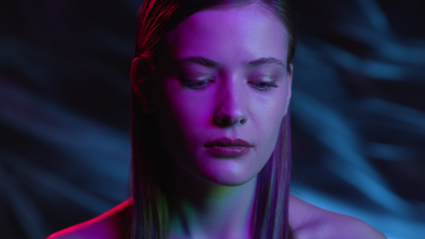Portrait of Woman Looking at Camera in Colourful Filter. Multi-Colour in Neon Light of Dark Room. Fashion of Gorgeous Girl at Night Club Indoors. Young Lady Watching on Ultra-Violet of Futuristic City Royalty-Free Stock Footage #1048130185