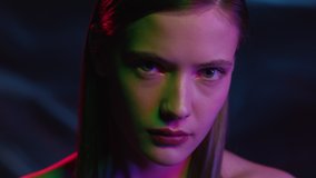 Portrait of Woman Looking at Camera in Colourful Filter. Multi-Colour in Neon Light of Dark Room. Fashion of Gorgeous Girl at Night Club Indoors. Young Lady Watching on Ultra-Violet of Futuristic City - Powered by Shutterstock - Get 15% off with code: PIKWIZARD15