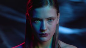 Portrait of Woman Looking at Camera in Colourful Filter. Futuristic Advertisement with Young Girl in Ultra-Violet of Night Club Indoors. Multi-Colours in Neon of Dark Room. Lady Watching on Lighting - Powered by Shutterstock - Get 15% off with code: PIKWIZARD15