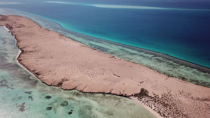 High angle aerial view of beautiful unspoiled tropical island, part of the Umluj group in the Red Sea, natural landscapes in Saudi Arabia
 Royalty-Free Stock Footage #1048134532