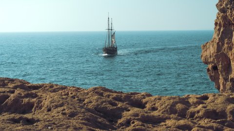 Slow-motion of pirate boat sailing towards the camera.
