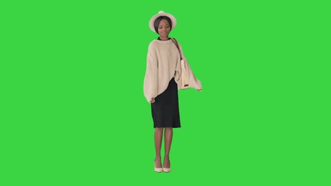 Gorgeous afro american woman listening music and dancing on a Green Screen, Chroma Key.
