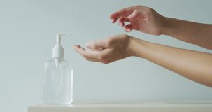 Coronavirus hand sanitizer sanitiser gel for clean hands hygiene corona virus spread prevention. Woman using alcohol rub alternative to washing hands. REAL TIME video.