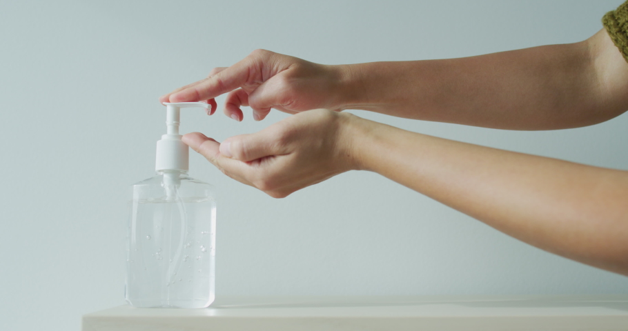 Coronavirus hand sanitizer sanitiser gel for clean hands hygiene corona virus spread prevention. Woman using alcohol rub alternative to washing hands. REAL TIME video. | Shutterstock HD Video #1048156045