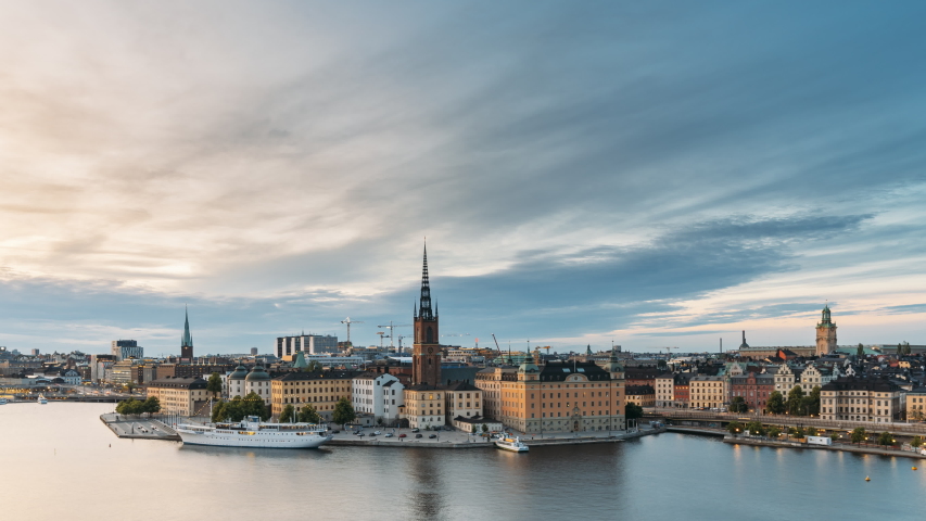 Stockholm, Sweden. Scenic View Of Stockholm Skyline At Summer Evening. Famous Popular Destination Scenic Place In Dusk Lights. Riddarholm Church In Day To Night Transition Time Lapse Royalty-Free Stock Footage #1048159753