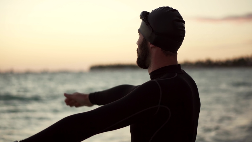 Swimmer Silhouette Training Triathlon In Open Water. Swimmer Stretching Exercise In Ocean.Professional Triathlete Prepare Swimming Workout Sport Recreation. Triathlete Ready Triathlon Competition Swim Royalty-Free Stock Footage #1048163101