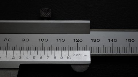Vernier calipers that have finished measuring and are closing quickly