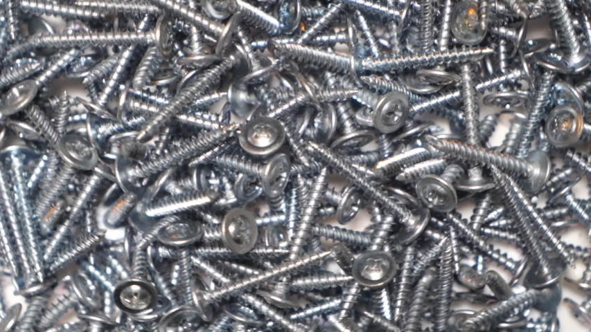 Sheet metal screw background. Pile of self-tapping screws rotation top view. | Shutterstock HD Video #1048172806