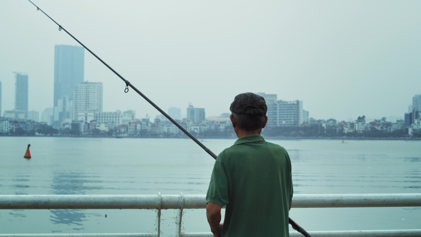 Handheld view of senior man fishing. Shot with RED helium camera in 8K